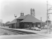 The utilitarian Port Colborne station completed in 1925, replaced a much more interesting building that was demolished to make way for the Fourth Welland Canal construction.  By the time this photo was taken the building housed both the CN Express Freight and the TH&B Freight office (originally at King and Clarence - 2nd floor). Contrast this with Arnold Mooney's photo taken 3 years later and you can see the Station Order Signal in his 1975 shot was moved to the north side of the tracks, and the Bridge #20 Semaphore was replaced by Search Lights http://www.railpictures.ca/?attachment_id=44074. The Dunnville Sub was still active and regularly used up till 1977.  In addition to steam era passenger service, the station was used by the Interurban Trolley NS&T from 1925 till 1959 (1911-1925 the Trolley terminated at the Imperial Bank - Charlotte and West). The King Street crossing appears to have had Flashing Lights and Wig-Wags(barely visible).  Jacob Patterson has posted a great colour image from 1955 at the same location.  http://www.railpictures.ca/?attachment_id=44470.  Garnet Henderson, a WWII veteran spent a couple of years working for the CNR out of Port Colborne in the early '50's... and who was Garnet Henderson... the father to the '72 Canada - Soviet Summit Series Hero - Paul Henderson  