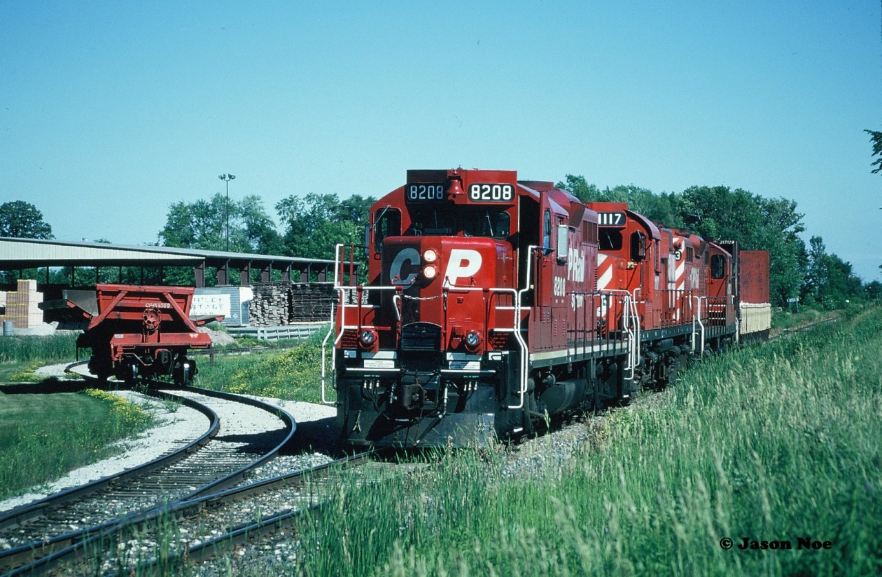 After lifting a car from the Brampton Brick Limited plant, CP 8208, 1117 and 8243, had then set-off the dump car in the small spur. The units would eventually reverse to their waiting northbound train on the Owen Sound Subdivision in Brampton once the brakeman climbed aboard the bulkhead car, which was likely sitting one crossing away at Sandalwood Parkway.