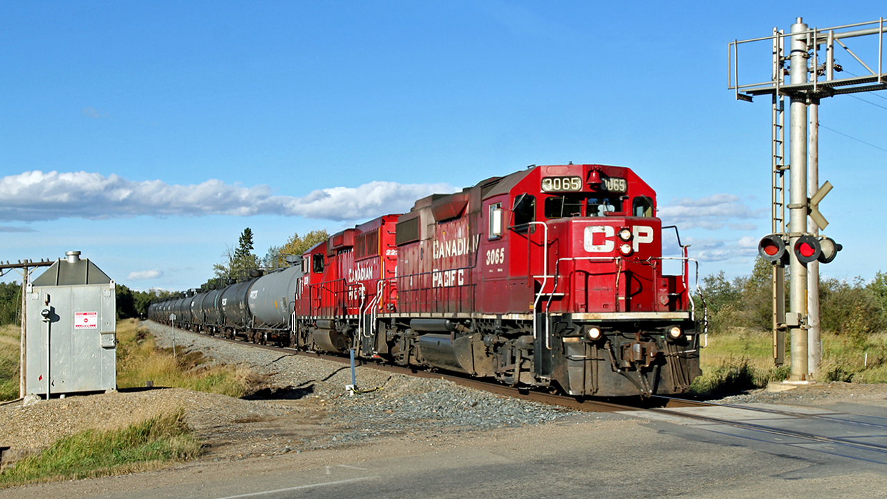 GP 38-2, CP 3065 and GP20C-ECO, CP 2221 work a local transfer of tank cars south into Red Deer.