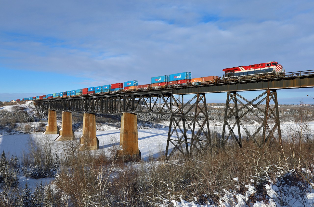 The BC Rail Heritage unit, CN 3115 leads Z 11251 17 over the North Saskatchewan River on a frigid December morning