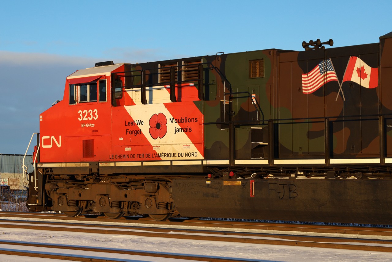 CN 3233, one of two locomotives sporting a camouflage paint scheme to honour our Veterans departs Edmonton.  If you look closely, an employee has written AIRBORNE on the fuel tank below the poppy.