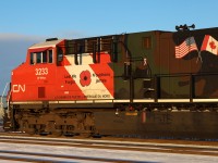 CN 3233, one of two locomotives sporting a camouflage paint scheme to honour our Veterans departs Edmonton.  If you look closely, an employee has written AIRBORNE on the fuel tank below the poppy.  