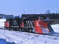 Plow extra 4530 heads back to Toronto Yard with the caboose leading the way.  If you look carefully, you can see the snow blowing up in front of the plow! The train most likely had been plowing the Uxbridge Sub.  Consist includes GP9s 4530 and 4527, plow 55220, and an unknown caboose.