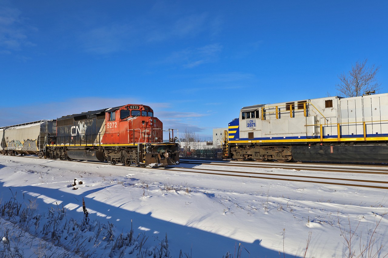 CN 5272 on the Herder sits at 149th Street as B 75941 17 rolls by with CN 3971, CN 3982, CN 3967 - DP 2x1x0 - 205 cars