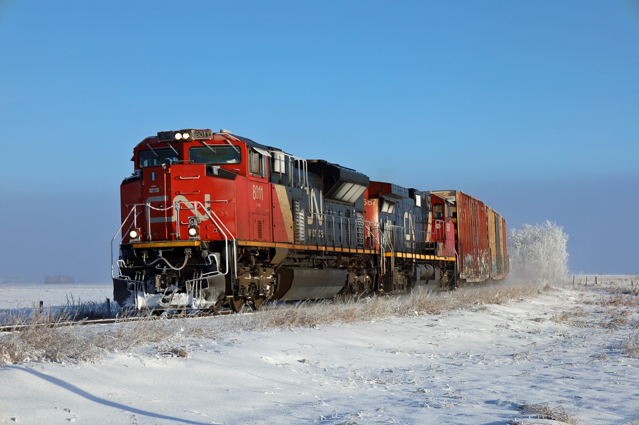 North Battleford to Edmonton A 41141 12 approaches Vegreville, Alberta on a chilly December morning.  If you look closely to the left of the locomotive, you can see a pair of CN units sitting at a grain elevator in the fog.