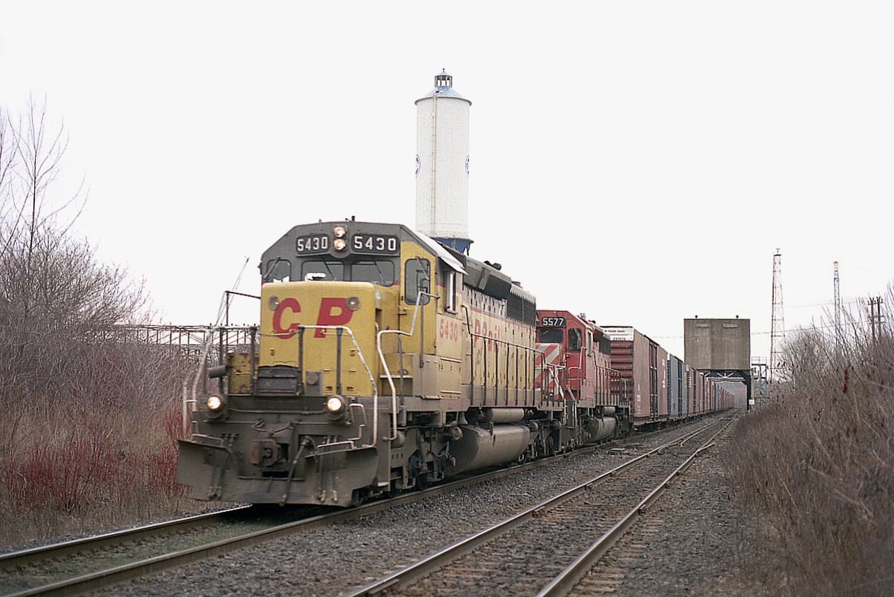 These "yellow" units really did not spend much time on CP before either being painted over or dealt off. They were former GATX units, leased by CP to the D&H (STLH) and eventually purchased by CP.  This particular one, CP 5430, was former GATX 2008 and a year after this image was taken was sold to Livingston Rebuild Center and became LLPX 4406, which I did catch leading a train on the Galt sub a few years after.
There were 10 SD40-2s leased from GATX (2000-2009) in 1991 and then purchased in 1994. I'm not sure how many actually made it to CP red.
Second unit on this #327 auto parts train, Buffalo to Talbotville, is #5577 and the train is just coming off the Welland Canal Bridge 6 on a rather dismal looking morning.