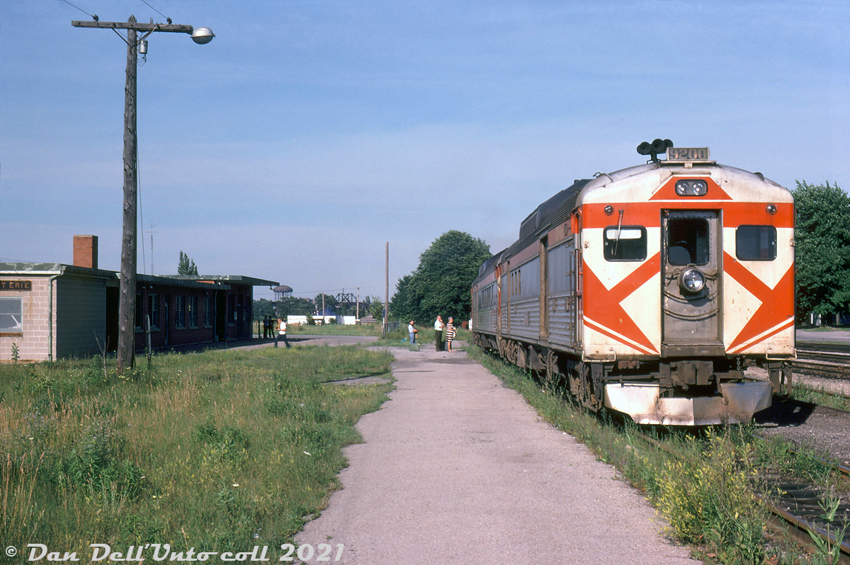 Passengers wait on the platform with their baggage before boarding the old CP/TH&B Budd run at the Fort Erie station. CP RDC-4 9200 and and unknown RDC-3 (possibly 9020, the only one John Street assigned at the time) make up today's consist. Based on the sun angle, I'd hazard a guess this is returning train #371/322 from Buffalo NY bound for Toronto Union Station (that called on Fort Erie just past 6pm, if on time). Some notable industrial Buffalo architecture is visible in the distance, across the Niagara River.

9200 was a shorter RDC-4 model that Budd had designed to carry cargo instead of passengers. It was built in September 1955 by Budd as a one-off car for CP: a lone car, configured with both baggage-express and mail sections. CP purchased two additional RDC-4's in July 1956, 9250 and 9251, but they featured a single large baggage-express section (and had the revised "Phase 2" ends).

Photos indicate 9200 saw service in New Brunswick in the 1950's, and did time in Sudbury in the early 70's, and Toronto in the mid-late 1970's on the CP/TH&B Budd runs from Toronto to Buffalo. 9200 was sold to VIA when they took over CP's passenger services in 1978, but unlike 9250-51 (that saw service on the Sudbury-White River runs, still in CP paint) 9200 didn't operate in VIA service. Instead, it was transferred from CP's Glen Yard to CN's Pointe St. Charles shop in 1979, and used for parts. The remains were sold for scrap to Dominion Metals & Refining Works (St. Constant QC) in February 1985.

Harold E. Brouse photo, Dan Dell'Unto collection slide.