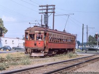 NS&T interurban car 80 has just pulled away from the Port Colborne station (just across King Street) and traffic flow is getting back to normal as the wig wag stops it's sway.  Must be a warm day with the windows and door open to get a breeze.<br><br>Port Colborne Station, <a href=http://www.railpictures.ca/?attachment_id=44470>steam power in 1955.</a><br><br><i>Original Photographer Unknown, Al Chione Duplicate, Jacob Patterson Collection Slide.</i>