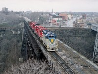 About 8 years ago I posted a shot of this train beginning to cross the Steel Arch bridge from Canada to the USA. I shot it from over the border, standing on the curb of the Robert Moses Parkway.  Well, finally; here is another image.  Having shot the first photo; I ran like blazes (I'm a slow moving blaze) to get another angle.
And this is it.  D&H 7309, CP 5529, SOO 6612, 6601 and 780. Crossing over.
This was heralded as the First International (CP) Grain Train; with three SOO representing the West; the CP 5529 representing the run thru Ontario, and at the NF Montrose Yard D&H 7309 arrived to lead the train over to New York State and the eventual run up the D&H line to Albany.
The weather was drizzling and gloomy.  I was rather hot and bothered. Unfortunately, so were the New York State police, the city police and the border patrol.  But it all worked out in the end, and they let me go........ It is illegal to walk on the elevated part of the parkway, and weird railfan activity just had to be investigated.

It has been 20 years since anything rolled over the Steel Arch bridge. Cost of demolition too high...so it just sits there.  The only active rail left there now is the CN. Station visible on the far right.........