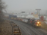 The snow has started to fall as CN 123 heads west with CN 3884 & CN 2868 for power after a crew change at Turcot Ouest.