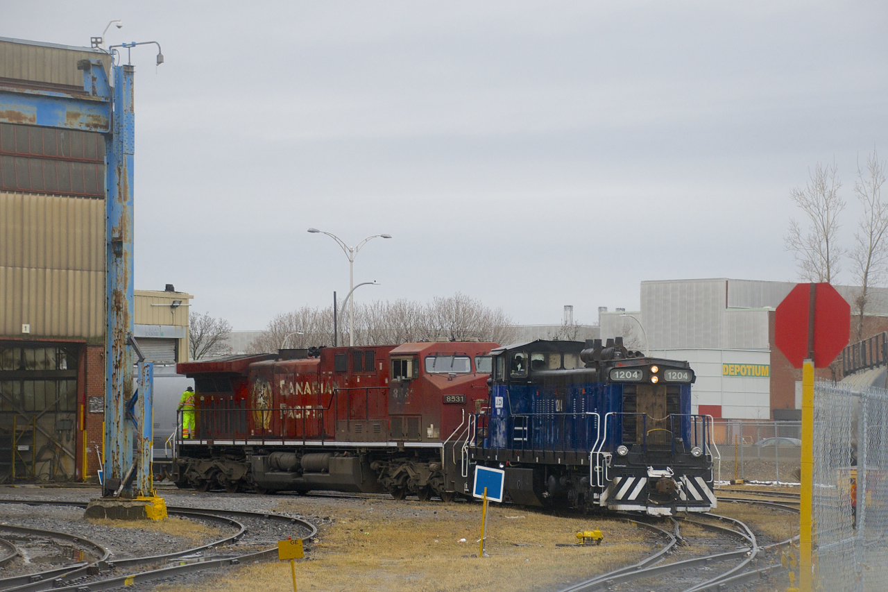 A GMD-1 is shoving CP 8531 into the shops at CAD on a gloomy afternoon. JLCX 1204 was built as CN 1070 in 1960 and was later renumbered to CN 1170 before being retired by CN in 2005. CP 8531 is a 1998 product of GE's Erie shops.