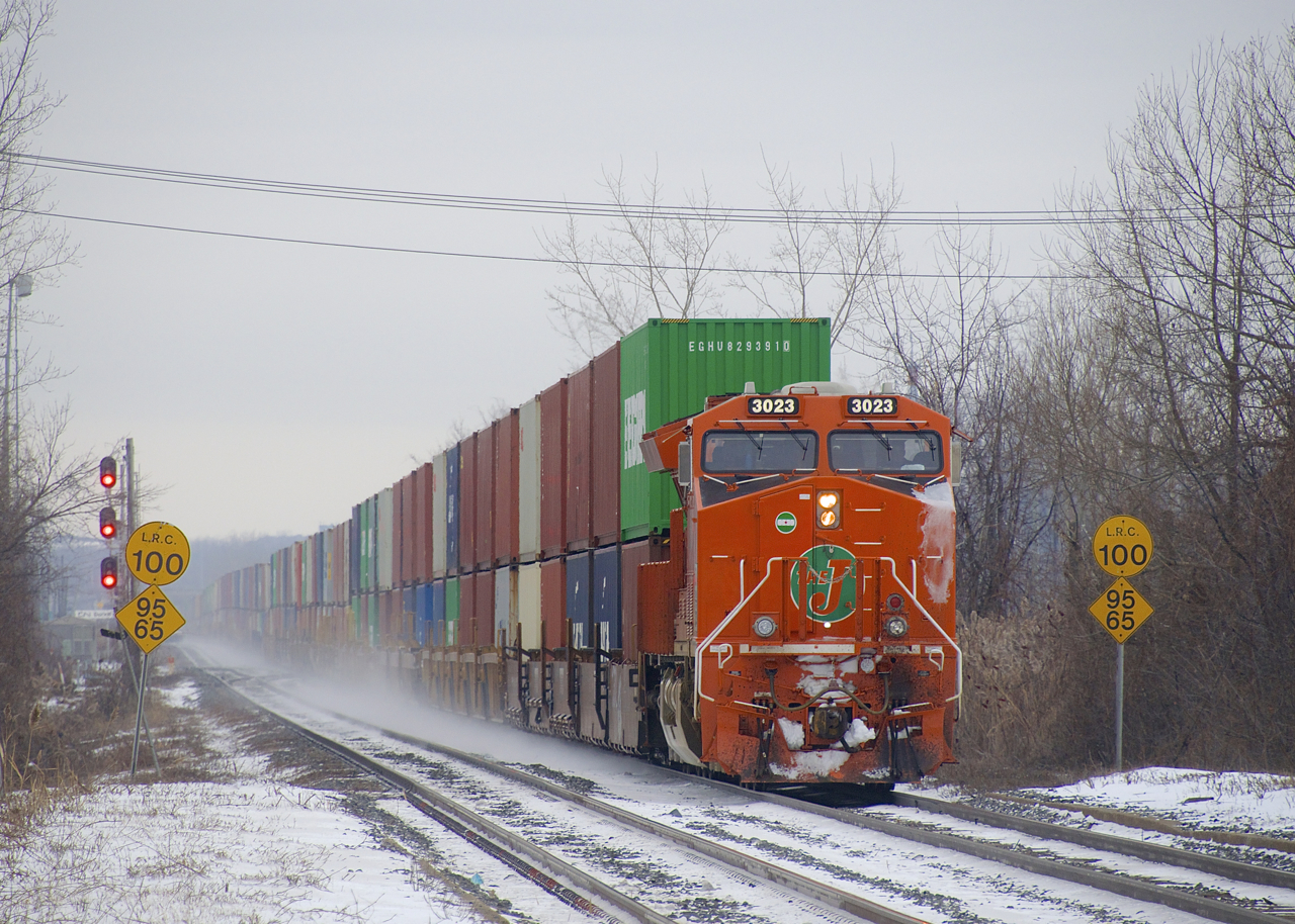 After a continent wide voyage from the Pacific coast port of Prince Rupert, CN 186's long journey is nearly over as it passes through Dorval with the EJE heritage unit leading. Mid-train is CN 3814 and distributed braking car CN 0083 is on the tail end of this 177-car train (10,738 feet long).