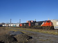 CN 324 is passing MP 3.13 of CN's Montreal Sub as it rounds a curve with a pair of SD70M-2's for power (CN 8957 & CN 8892). The trailing unit was repainted with a white cab roof at some point.