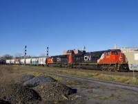 CN 324 is passing MP 3.13 of CN's Montreal Sub as it rounds a curve with a pair of SD70M-2's for power (CN 8957 & CN 8892). The trailing unit was repainted with a white cab roof at some point.