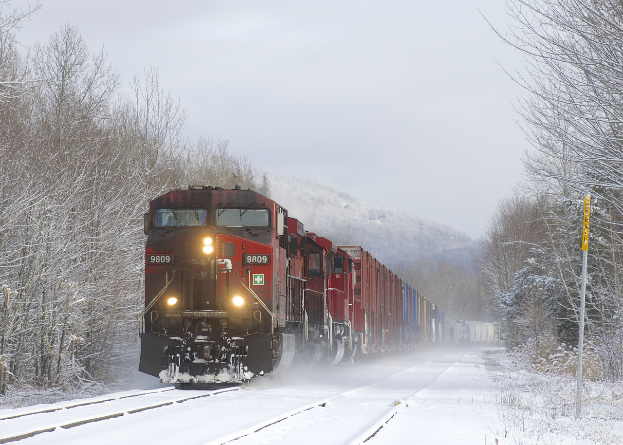 CP 251 rounds a curve in Bromont as it passes the siding located there with a dirty GE leading.
