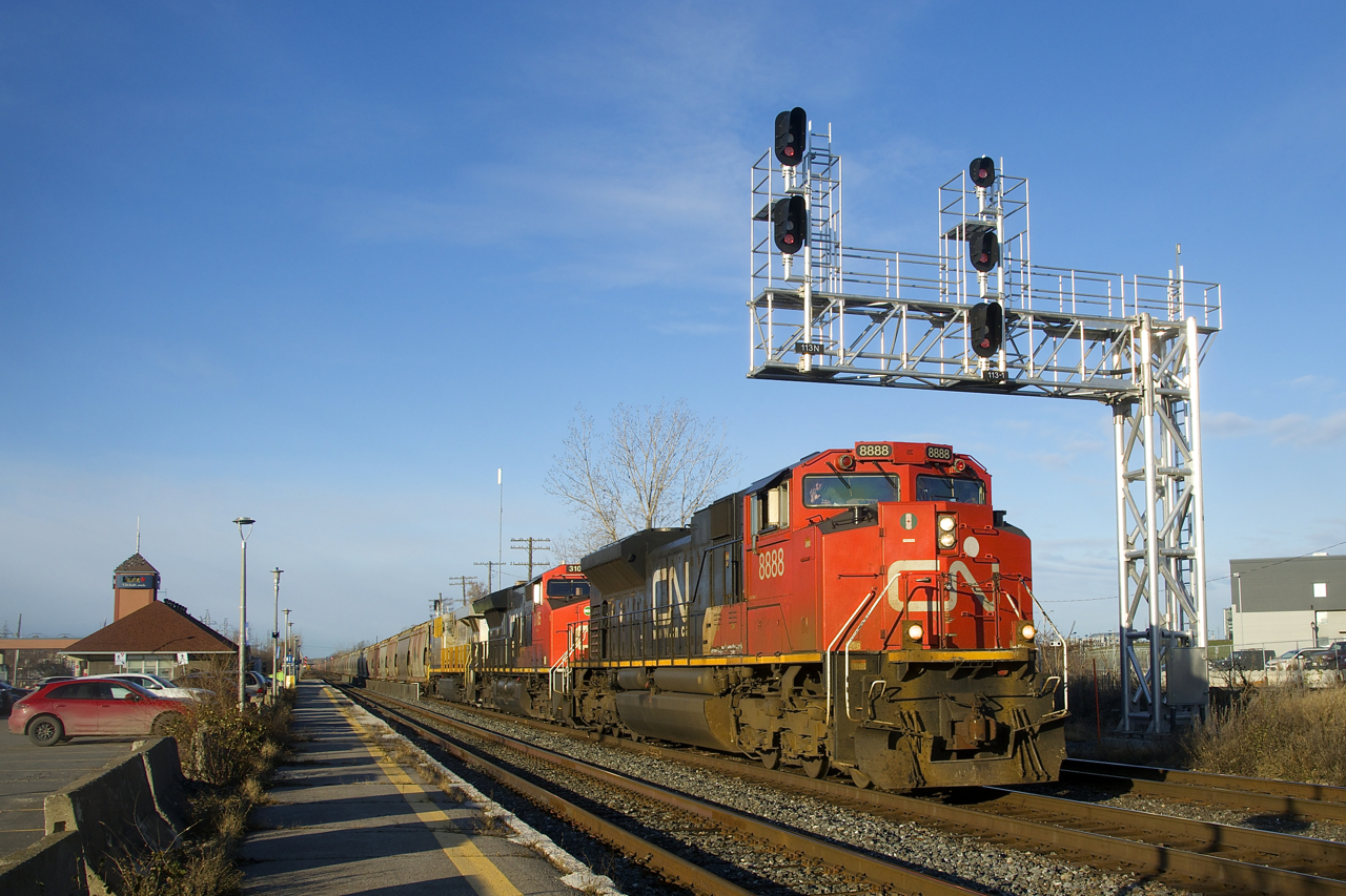 Added as leader at Capreol to put a rare non-AC unit on this train, CN 8888 is passing under a signal gantry as CN B730 roars through Dorval with five units online (CN 8888, CN 3105 & CN 3936 up front, CN 3927 mid-train and CN 2958 on the tail end). This potash train has the usual 205 loaded cars and weighed in at 30,343 tons including the power.