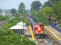 CP 8208 (ex-CP 8560) looks good in fresh paint as it passes Cedar Park Station on the head end of ethanol train CP 650.