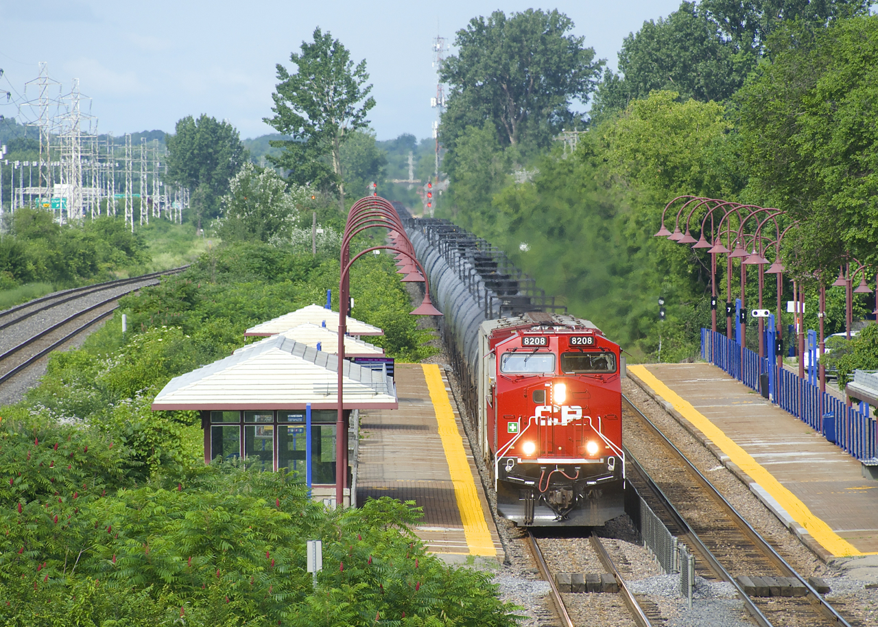 CP 8208 (ex-CP 8560) looks good in fresh paint as it passes Cedar Park Station on the head end of ethanol train CP 650.