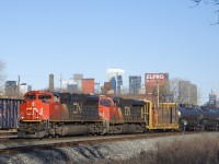 CN 305 is passing a parked CN X306 as it passes underneath the skyline of downtown Montreal with CN 8949 & CN 2812 up front.