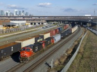 CN 305 has a pair of Dash9s for power (IC 2720 & CN 2564) as it approaches Turcot Ouest. There it will set off the first 23 cars and continue west as a solid train of potash empties (175 of them). At left is a parked CN X306.