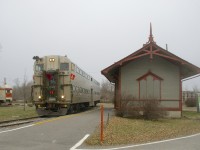 After sitting unused for a decade, Exporail's volunteers have got cab car AMT 900 running and with passengers on board as it leads the Christmas Train past Barrington Station as a bit of snow begins to fall.