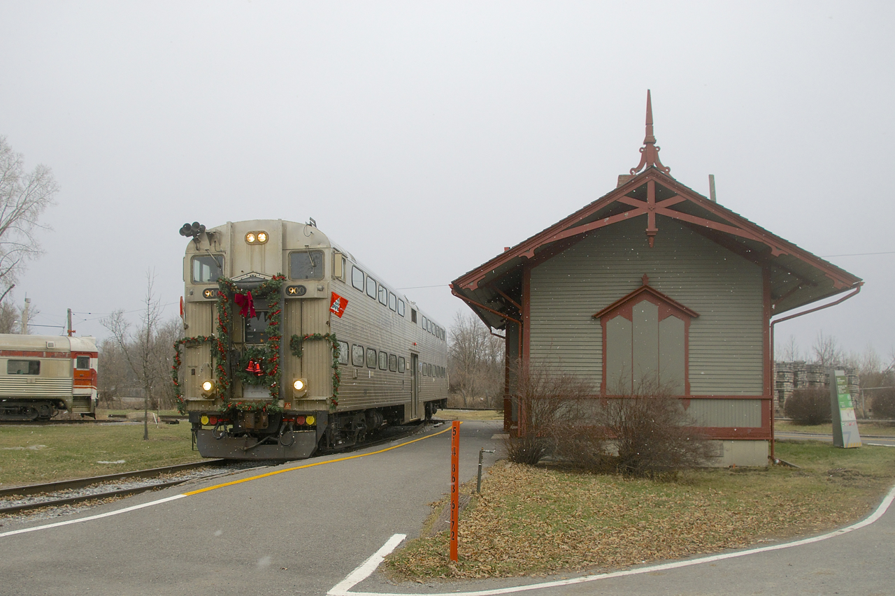 After sitting unused for a decade, Exporail's volunteers have got cab car AMT 900 running and with passengers on board as it leads the Christmas Train past Barrington Station as a bit of snow begins to fall.