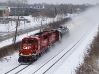 CP F95 is kicking up quite a bit of snow as it rockets through Pointe-Claire with CP 2307, CP 3108 and nine tank cars.
