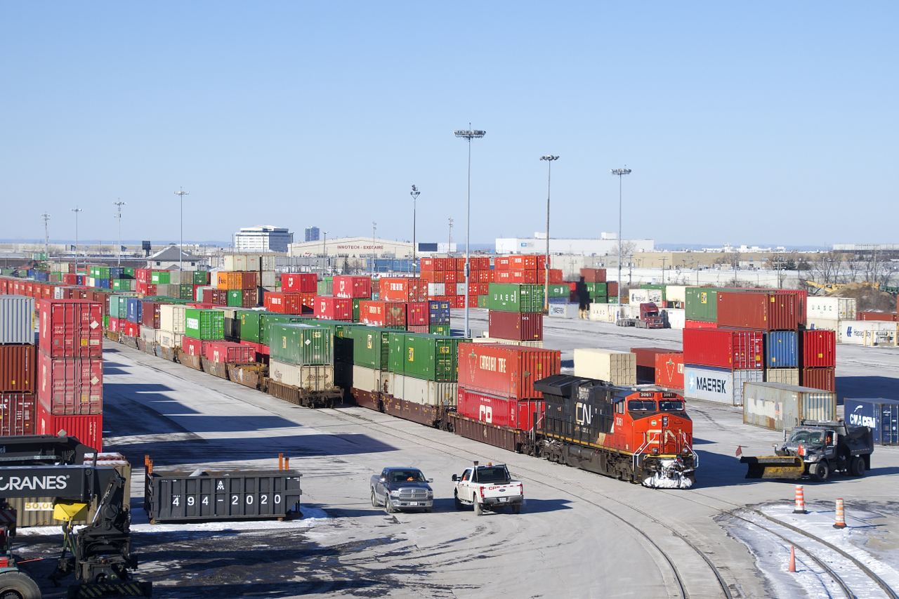 CN 3061 looks out of place in CP's Lachine IMS Yard as it slowly leads CP 112 through the yard on a frosty morning.