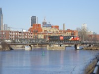 A CN 100 unit is leading CN 322 over the Lachine Canal. On the tail end is CN 3255; normally this train has a DPU on the tail end after it sets off cars at Taschereau Yard. It will terminate at Soutwark Yard.
