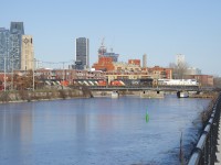CN 120 crosses the frozen Lachine Canal with an ex-CREX leader (CN 3954). Trailing are CN 3159, CN 9454 & CN 9543.