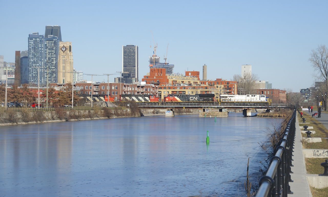 CN 120 crosses the frozen Lachine Canal with an ex-CREX leader (CN 3954). Trailing are CN 3159, CN 9454 & CN 9543.