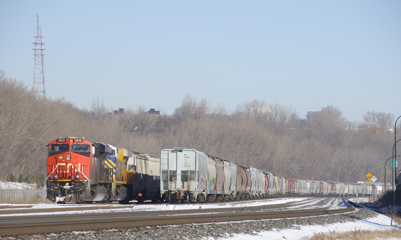 CN 305 is temporarily tied down on Track 29, with CN 2912 & CN 3933 for power. At right are a large number or parked grain cars.