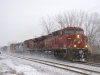 CP 251 is passing by Exporail with a pair of AC4400CW's and a pair of GP38-2's for power (CP 9675, CP 8584, CMQ 3817 & CP 3108) as the snow comes down.