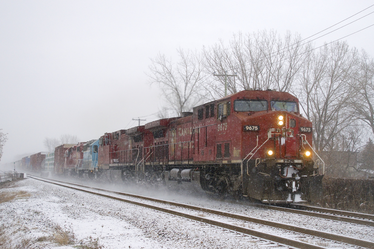 CP 251 is passing by Exporail with a pair of AC4400CW's and a pair of GP38-2's for power (CP 9675, CP 8584, CMQ 3817 & CP 3108) as the snow comes down.