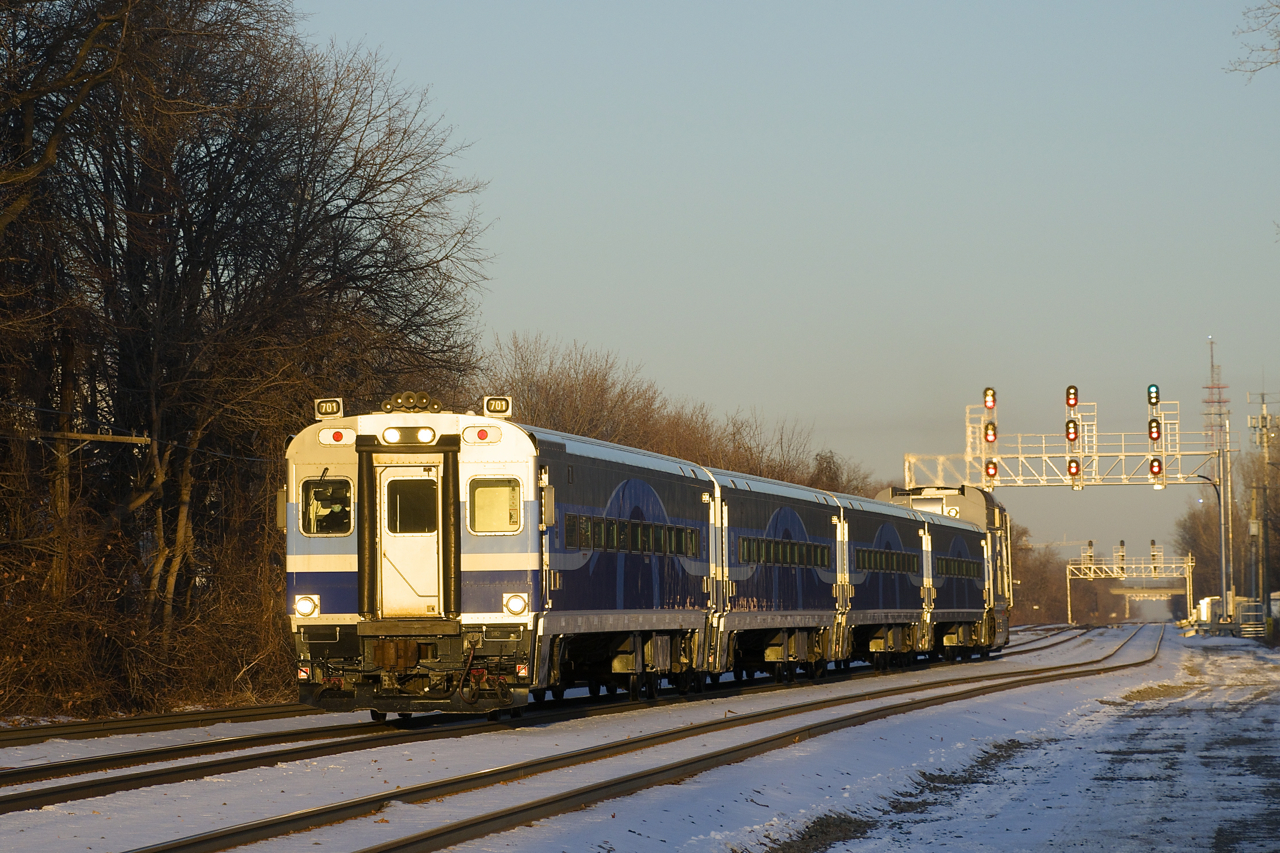 Cab car AMT 701 is leading EXO 81 as it approaches Montreal West Station just before sunset.