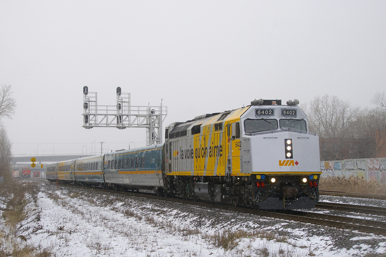 On a cold and slightly snowy morning, VIA 24 has VIA 6402 for power, one of the cleaner F40 wraps. In the distance at far left is a parked CN B730.