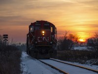 Taking it easy on a Friday evening, a pair of aged workhorses trundle their way home to Preston along the Fergus spur.  Mile 27 sits just about one quarter mile west of the former <a href=http://www.railpictures.ca/?attachment_id=35650>settlement of Gourock.</a>  Originally founded circa 1857 just after the building of the Galt & Guelph Railway (leased to the Great Western upon completion), the settlement included a post office, general store, and a flag stop on the railway, but little else.  The post office ceased to be in 1913, and the flag stop too was gone shortly after, not shown in the 1920 Grand Trunk Railway timetables.  Any inhabitants made their way north to Guelph, and some a few miles south to the lime quarry town at <a href=http://www.railpictures.ca/?attachment_id=35419>Glen Christie.</a><br><br>The morning of September 22, 1906 saw a fatal head on collision at Gourock within a few hundred feet of Steve's photo linked above.  An extra train loaded with fruit from St. Catharines had failed to take the siding at Hespeler to clear the main for train 44, the mixed from Guelph.  Neither crew saw the oncoming train until just a few hundred feet from impact.  Engineer Thomas Farley on #44 was crushed in the cab, his fireman, Lorne Palmer, jumped clear.  On the extra, engineer Mark Reid, brakeman Harry Andrews, and fireman Cecil Bright all jumped, suffering full body scalding and Cecil suffering numerous broken bones.  All were transported to Guelph for medical care.  Reid and Andrews would recover, while Cecil Bright succumbed to his injuries at Guelph General Hospital on September 25.  The ten passengers onboard 44 sustained only minor injuries.  Factors of the wreck included crew fatigue and working hours as the conductor of the extra, Joe Thompson, had fallen asleep after being on duty for twenty two hours, and his exhausted engineer had forgotten a meet was imminent.<br><br>Some scenes of the Gourock Wreck:<br>North side of the tracks <a href=https://s3.amazonaws.com/pastperfectonline/images/museum_460/156/ph44604.jpg>facing east,</a><br>South side of tracks <a href=https://s3.amazonaws.com/pastperfectonline/images/museum_460/156/ph44605.jpg>facing east.</a>  Note the curve from Steve's photo just above the wrecking cranes.<br><br>*Thanks to the late Wellington County historian, Stephen Thorning, (1949 - 2015) for extensive information regarding the wreck.