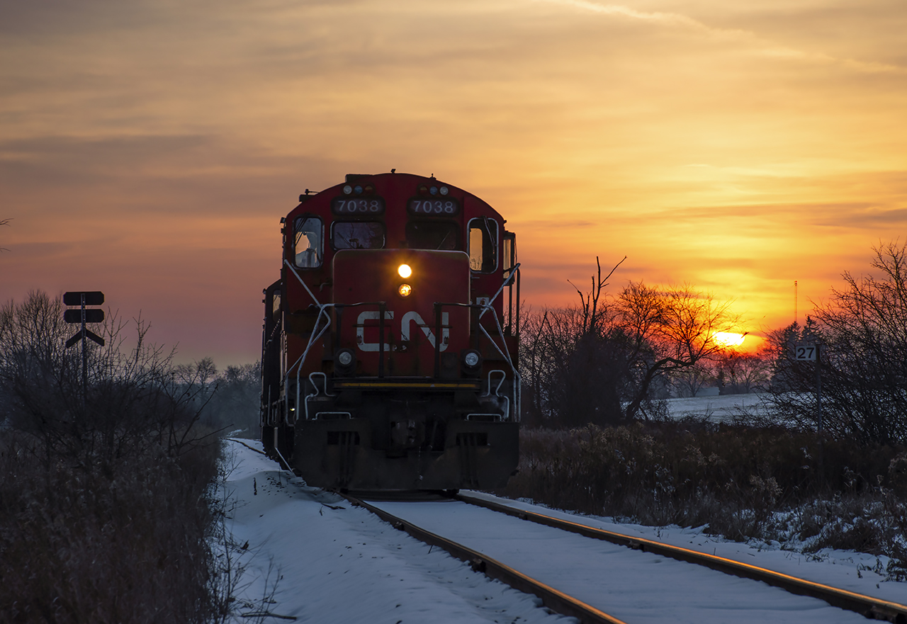 Taking it easy on a Friday evening, a pair of aged workhorses trundle their way home to Preston along the Fergus spur.  Mile 27 sits just about one quarter mile west of the former settlement of Gourock.  Originally founded circa 1857 just after the building of the Galt & Guelph Railway (leased to the Great Western upon completion), the settlement included a post office, general store, and a flag stop on the railway, but little else.  The post office ceased to be in 1913, and the flag stop too was gone shortly after, not shown in the 1920 Grand Trunk Railway timetables.  Any inhabitants made their way north to Guelph, and some a few miles south to the lime quarry town at Glen Christie.The morning of September 22, 1906 saw a fatal head on collision at Gourock within a few hundred feet of Steve's photo linked above.  An extra train loaded with fruit from St. Catharines had failed to take the siding at Hespeler to clear the main for train 44, the mixed from Guelph.  Neither crew saw the oncoming train until just a few hundred feet from impact.  Engineer Thomas Farley on #44 was crushed in the cab, his fireman, Lorne Palmer, jumped clear.  On the extra, engineer Mark Reid, brakeman Harry Andrews, and fireman Cecil Bright all jumped, suffering full body scalding and Cecil suffering numerous broken bones.  All were transported to Guelph for medical care.  Reid and Andrews would recover, while Cecil Bright succumbed to his injuries at Guelph General Hospital on September 25.  The ten passengers onboard 44 sustained only minor injuries.  Factors of the wreck included crew fatigue and working hours as the conductor of the extra, Joe Thompson, had fallen asleep after being on duty for twenty two hours, and his exhausted engineer had forgotten a meet was imminent.Some scenes of the Gourock Wreck:North side of the tracks facing east,South side of tracks facing east.  Note the curve from Steve's photo just above the wrecking cranes.*Thanks to the late Wellington County historian, Stephen Thorning, (1949 - 2015) for extensive information regarding the wreck.