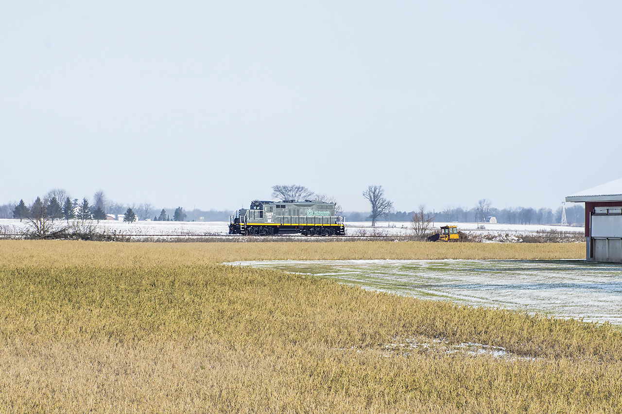 Power for GIO Rail's new Cayuga Subdivision operation arrived in St. Thomas during the night in the form of LDSX 1597, a former CP GP9u that has had some work done, including a new GIO Rail paintjob, by LDS, and it would appear the unit is being leased long term from LDS.  Making it's first run east today, the engine is seen approaching the village of Corinth east of Aylmer headed for Tilsonburg where it will down down at the yard.This portion of the Cayuga has seen a lot of work by GIO over the last few months, including thousands of new ties and ongoing work on crossing protection systems for increased speed, requiring most crossings today to be flagged by GIO personnel.Built as CPR 8687 in 1957, rebuilt to 1597 in 1985, to Larry's Truck and Electric in 2015, leased to the Delta Southern Railroad and later purchased and repainted in 2017, and finally to LDS.