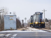 The first train to the south end of Tilsonburg since <a href=http://www.railpictures.ca/?attachment_id=43993>April 2020</a> is seen arriving in town about to cross Highway 19/Vienna Road as it enters the Tilsonburg Yard.  It will tie down just east of the crossing.