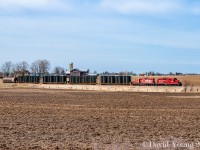 The crew of the day Woodstock yard is rolling through the empty farm fields of Middlesex County on a gorgeous Spring day. GP9u's CP 8201 and STLH 8245 are (timetable) eastbound with 4 loaded frame cars ex Formet in St Thomas destined for the Oshawa GM plant. Bringing up the rear is a hopper destined for Putnam which has been towed the length of the line and back. The crew will set it off and lift five before returning to Woodstock.