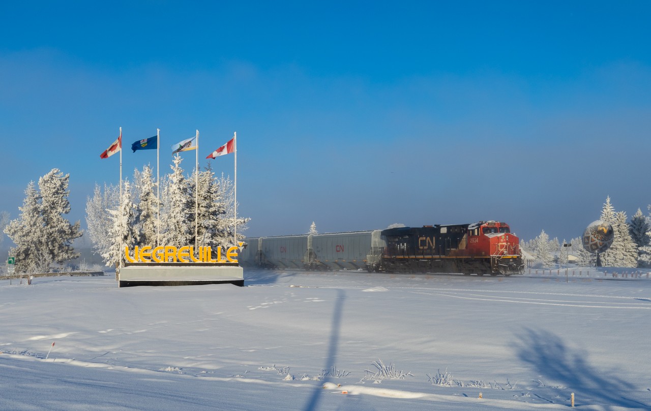 G 24351 11 highballs through Vegreville, passing the Worlds Largest Pysanka Egg.