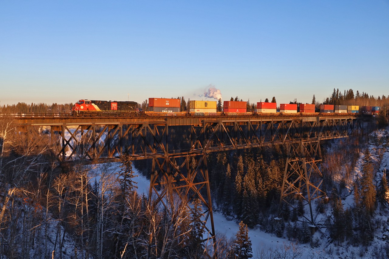 Q 19991 03 rolls across the Pembina River with CN 3877, CN 2907 and 188 cars bound for the port of Prince Rupert