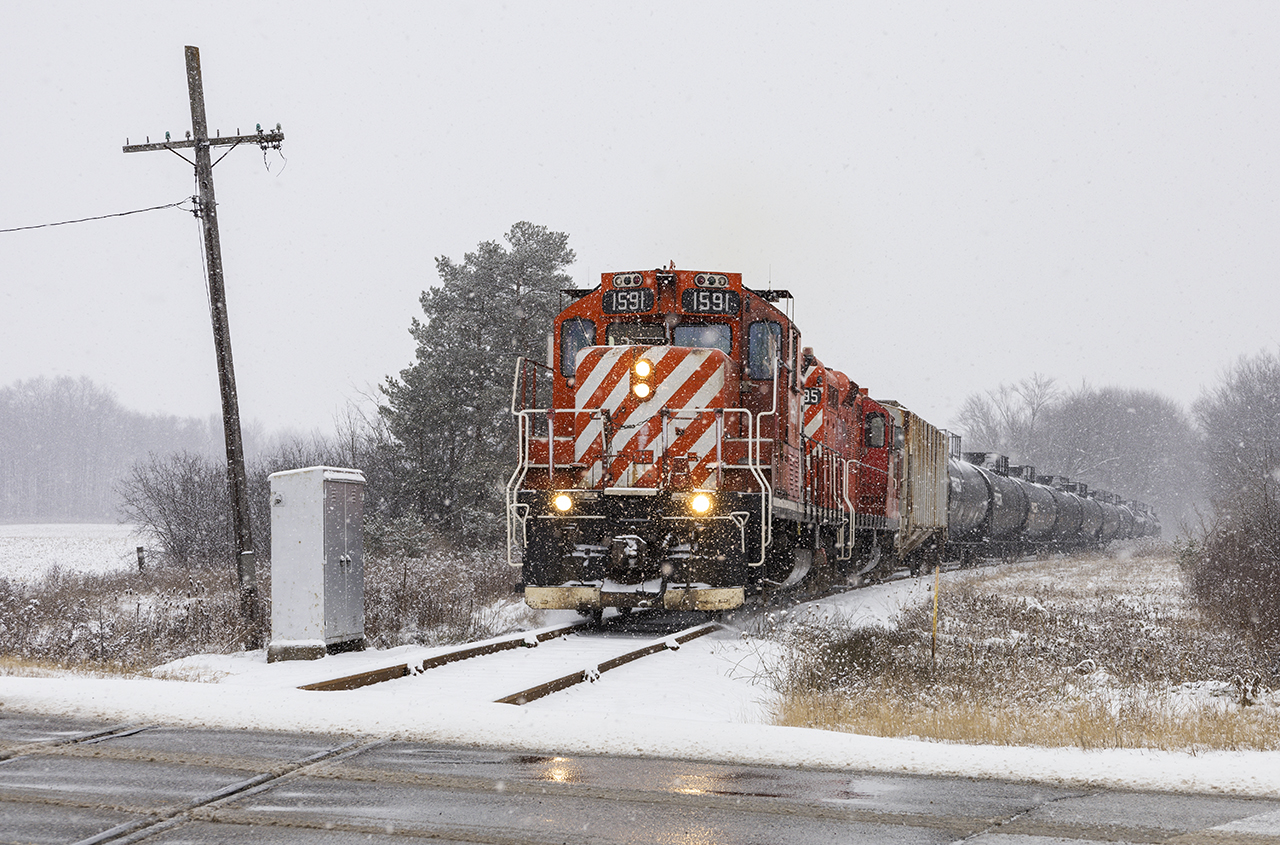 A fine pair of former CP GP9us still wearing their action red paint take the St. Thomas turn south nearing Belmont.