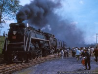 With 16 months left before retirement in September 1964, Canadian National Railways 6167 is seen smoking it up during its excursion career, pausing for water at Caledonia at the corner of Inverness Street and Orkney Street West (note crossbucks at right) in May 1963.  Today 6167 is <a href=http://www.railpictures.ca/?attachment_id=43749>on display at Guelph</a> as part of the Guelph Museums' collection.  Recently the locomotive's tender was coupled to the locomotive after sitting separate since the <a href=http://www.railpictures.ca/?attachment_id=43392>move to Priory Park</a> in 2020.  New windows and a coat of paint are planned in the near future.<br><br><i>Paul Morrissey, Jacob Patterson Collection Slide.</i>