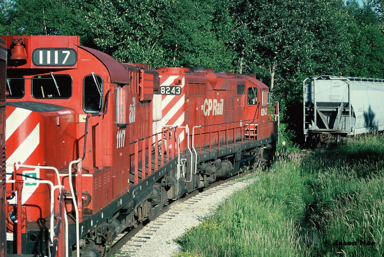 Seen from the cab of the Moonlight, units CP 8208, 1117 and 8243 have just set-off the two covered hoppers by the plant behind the Tim Hortons in Orangeville that today is Roechling Engineering Plastics. It might have still been named that during 1997.