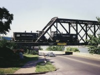 Back in the early days of Conrail and these switchers had not yet been painted over into the Conrail blue. Penn Central 9567 and 9576 are seen rolling over the bridge to Canada to pick up some traffic to take Stateside. At times I shot from this angle, even though I was not fond of it as in the summer months the sun would be dead on, making for a difficult shot. I'm guessing this image shot around 1900 hrs. Rather late for this move.