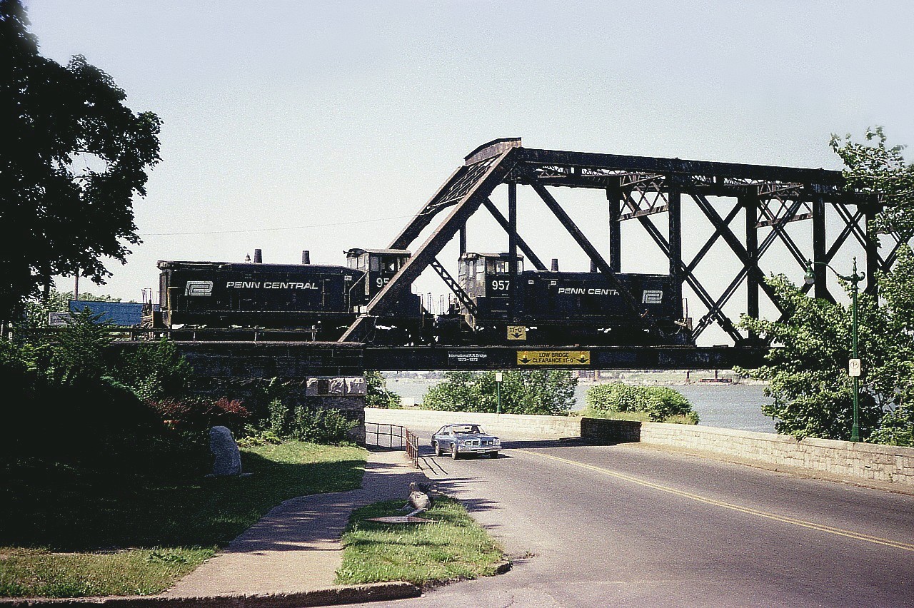 Back in the early days of Conrail and these switchers had not yet been painted over into the Conrail blue. Penn Central 9567 and 9576 are seen rolling over the bridge to Canada to pick up some traffic to take Stateside. At times I shot from this angle, even though I was not fond of it as in the summer months the sun would be dead on, making for a difficult shot. I'm guessing this image shot around 1900 hrs. Rather late for this move.