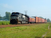 I visited Ingersoll a lot in my early days of photography. You had the CN mainline which hosted CN, VIA, and NS daily trains, as well as the CP Branchline and OSR Port Burwell at Ingersoll. And just 8 minutes north of town you had the CP mainline. A great place to catch a lot of action and back then every other train had something 'old' on it so a young guy like me could spend the day and catch up without much effort, we just had to take pictures of whatever rolled by. The Exhibit car on this train was for the St. Thomas Railway days, and we knew in advance it was coming (via press releases), we just didn't know exactly when. So when the day came word got out on the Internet and I beelined it with friends for Ingersoll on a very a foggy morning, arriving about 0830 (we missed NS 328 however). After a few trains, the fog finally burned off and NS 327 arrives at 0949 with their gigantic train, and the chase was on. The motive power, a boring Dash 9 would make any American yawn, but it was still a welcome distraction from the usual for us Canadians. Some days, however, the power was <a href=http://www.railpictures.ca/?attachment_id=33108 target=_blank>Glorious</a>.