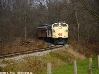 In Oxford County, an OSR Business train is reversing around a curve before heading under the 401 after departing salford, in reverse.